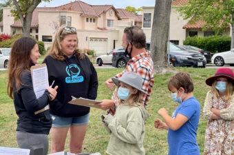 SDFA members gathering signatures on petitions outdoors