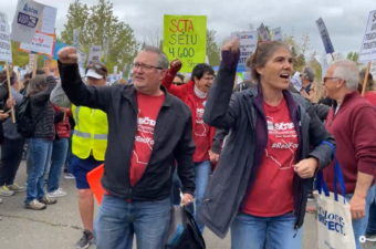 Educators raise their fists and march during the sixth day of the strike.