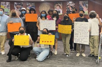 Protestors with signs about menstrual equity