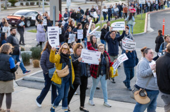 SAEA members protest the proposed layoffs.